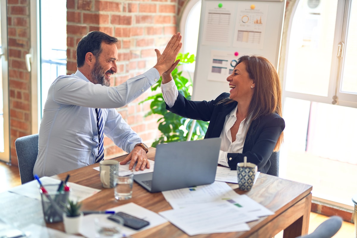 Two advisers comparing Portugal Golden Visa and D7 visa residency options at a desk